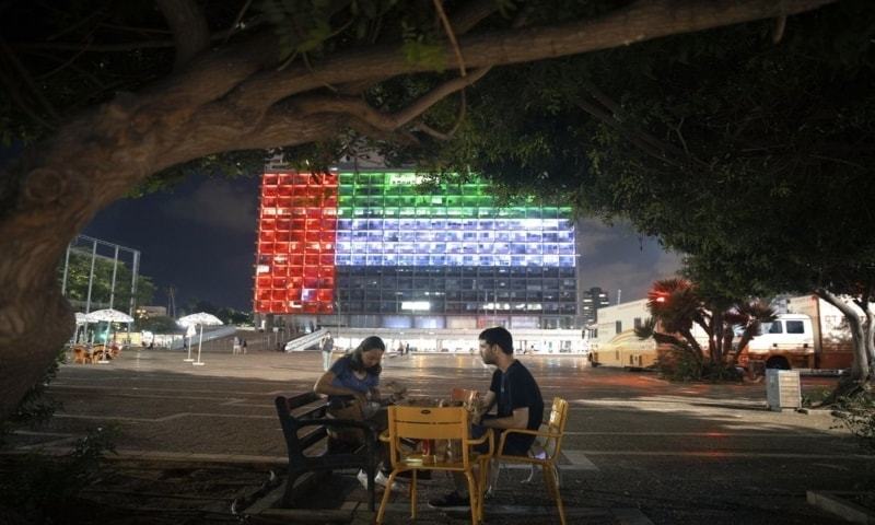 Tel Aviv City Hall is lit up with the flags of the United Arab Emirates and Israel as the countries announced they would be establishing full diplomatic ties on Thursday. — AP