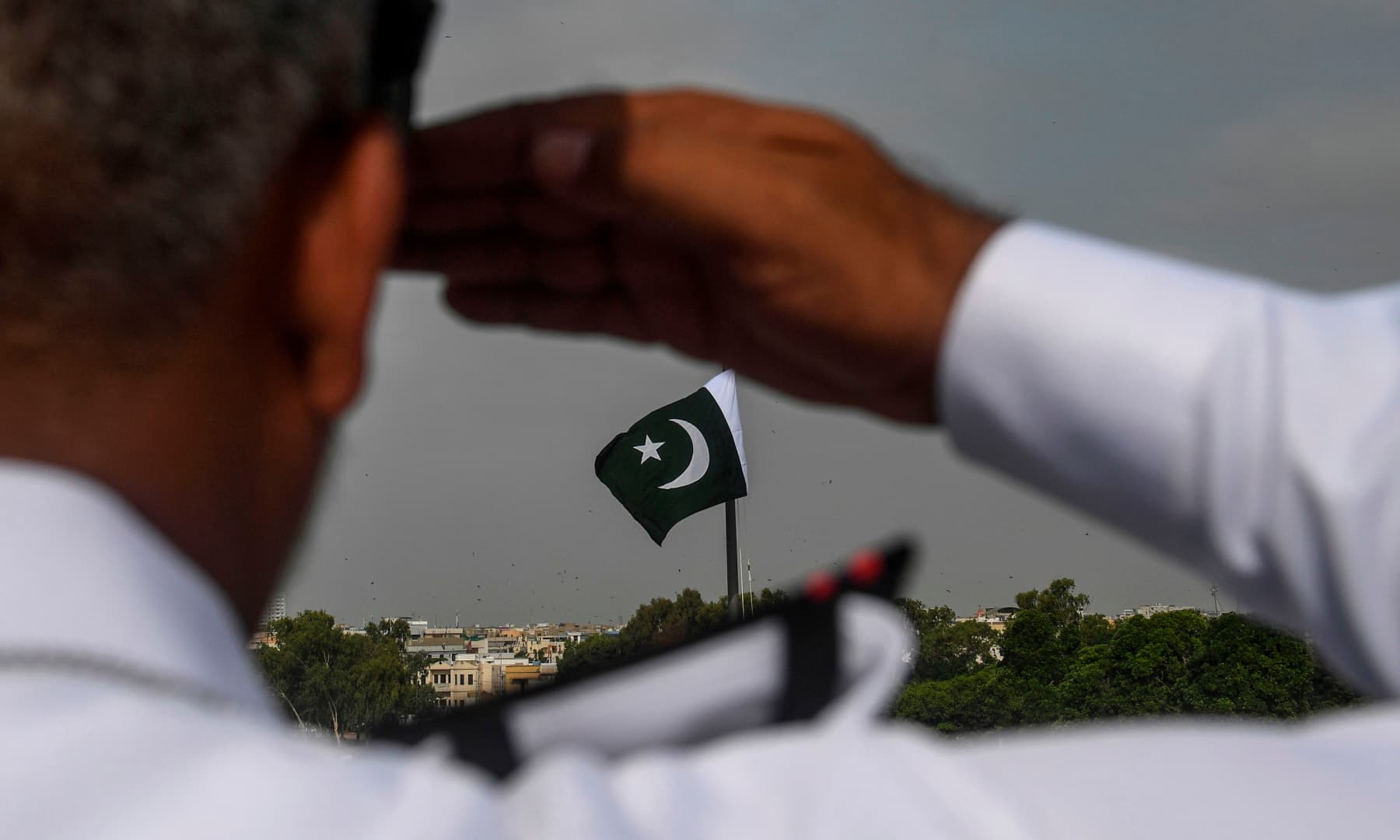 A Pakistan Navy officer salutes at the mausoleum of founder Muhammad Ali Jinnah during the Independence Day celebrations in Karachi on August 14. — AFP