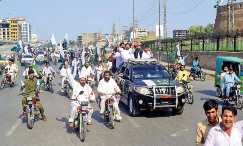 An Independence Day rally passes through a road in Peshawar. &mdash; APP