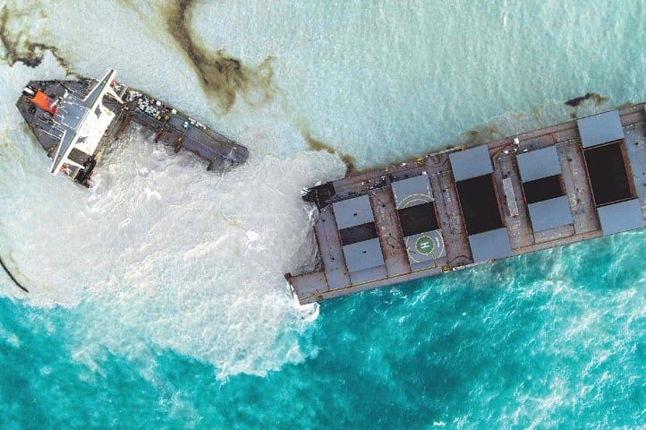 THIS aerial picture taken on Sunday shows the oil tanker MV Wakashio after it broke into two parts near Blue Bay Marine Park, Mauritius. The ship had run aground recently and leaked more than 1,000 tonnes of oil in pristine waters off the Mauritius coast.—AFP