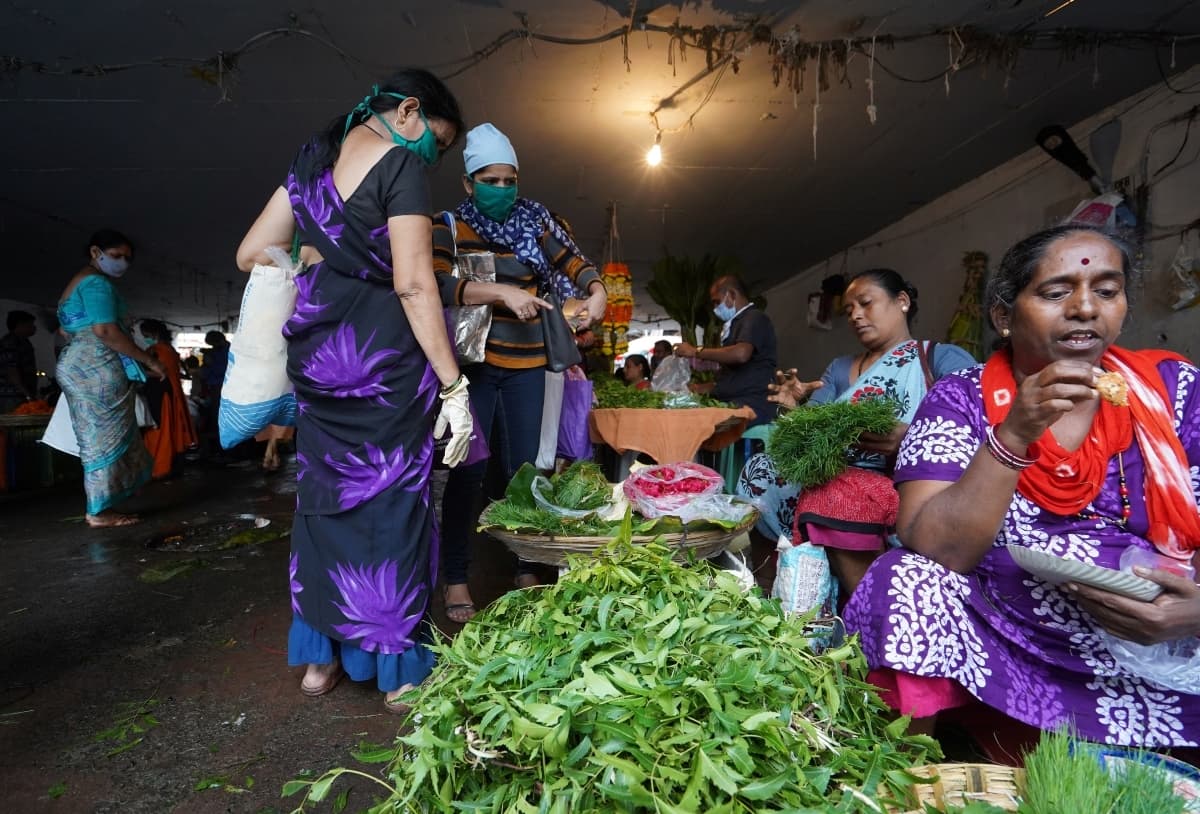 Women wearing protective face masks buy vegetables in a market, amidst the spread of the coronavirus disease in Mumbai, India, August 20, 2020. — Reuters