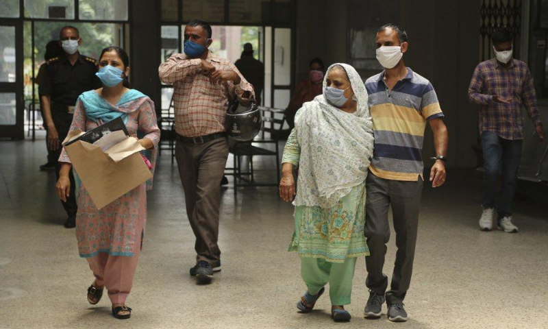 Indians wearing face masks arrive to consult doctors at a Covid-19 screening facility inside a government run hospital. &mdash; AP/File