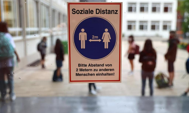 A sign reads "Social distance" as schools re-open after summer holidays and the lockdown due to the outbreak of the coronavirus at the Karl-Rehbein high school in Hanau, Germany. — Reuters