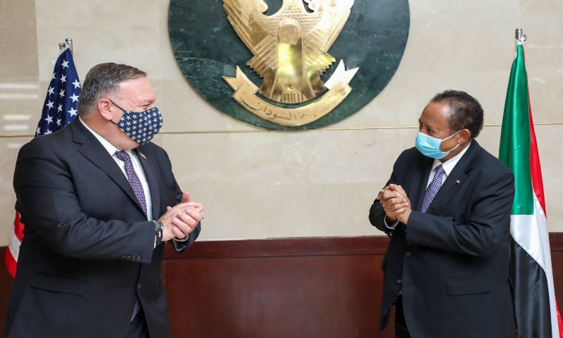 A handout picture provided by Sudan's Prime Ministers office on August 25, 2020, shows US Secretary of State Mike Pompeo (L) greeting Sudanese Prime Minister Abdalla Hamdok (R) in Khartoum. — AFP