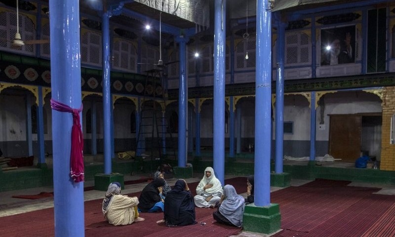 Kashmiri Shia Muslim women beat their chest during commemoration of Muharram inside a shrine in Srinagar on August 22. — AP