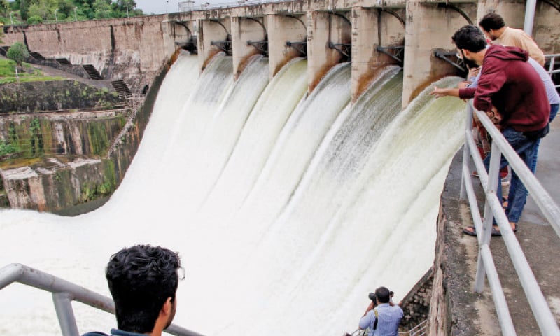 Water flows from Rawal Dam after its spillways were opened on Monday. Following the recent rain, the dam filled to its capacity, prompting the relevant authorities to release around 6,000 cusecs of water. — Photo by Mohammad Asim Water flows from Rawal Dam after its spillways were opened on Monday. Following the recent rain, the dam filled to its capacity, prompting the relevant authorities to release around 6,000 cusecs of water. — Photo by Mohammad Asim