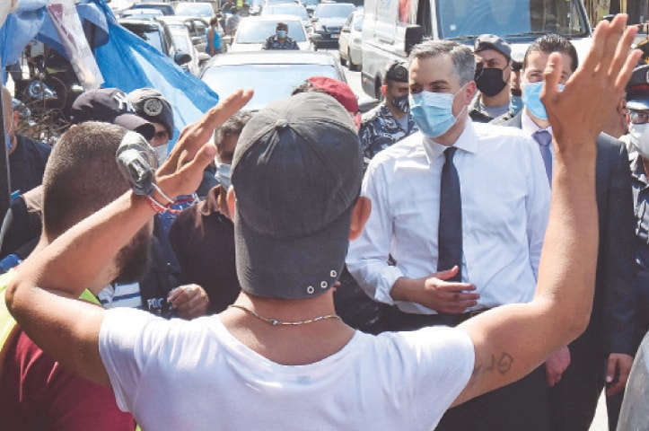 BEIRUT: Protesters confront Mustapha Adib (centre), the newly-appointed Lebanese prime minister, during a tour of Gemmayzeh, a neighbourhood devastated by the Aug 4 explosion at the port.—AFP