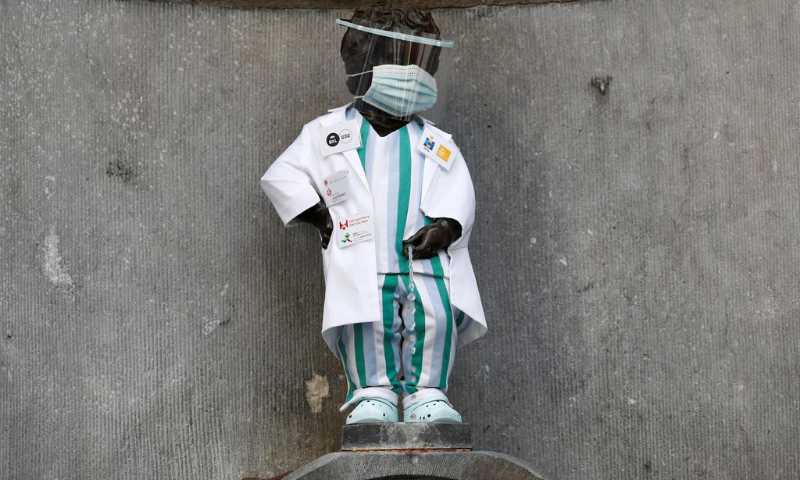 The Manneken Pis statue is dressed in an outfit paying tribute to healthcare workers during the coronavirus outbreak in Brussels, Belgium. &mdash; Reuters