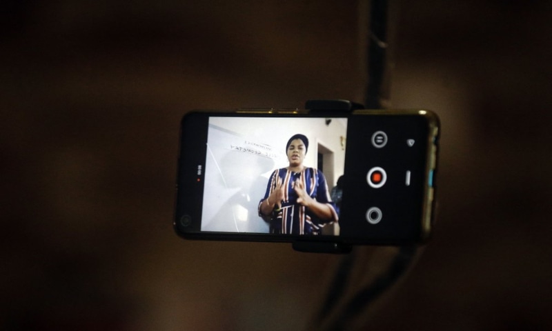 Mathematics teacher Basirat Olamide Ajayi, 36, teaches online via her mobile phone from her house in Lagos, Nigeria on August 15, 2020. — AP