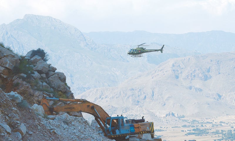 (CLOCKWISE): Rescue 1122 personnel, miners and volunteers take part in an operation on Tuesday to rescue survivors and recover bodies of the deceased from the mines in the Ziarat area of Mohmand tribal district that collapsed a day earlier; a military helicopter hovers over the ill-fated mines; army men remove the body of a miner; and, a general view of the operation.—Abdul Majeed Goraya/AFP