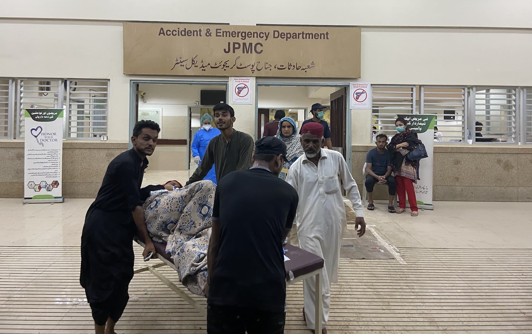 “Carrying weapons is prohibited,” state the posters glued to the main entrance of the emergency ward of JPMC. — Photo by Rabia Bugti