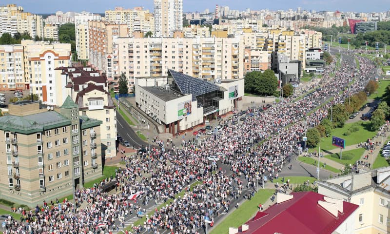 MINSK: Opposition supporters parade through the streets during a rally on Sunday to protest against the Belarus presidential election results.—AFP