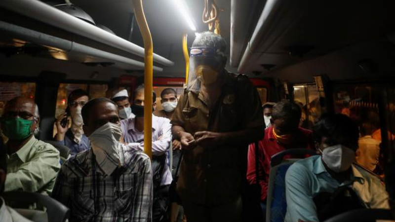 People travel in a bus wearing face masks amid the coronavirus outbreak in India. &mdash; Reuters