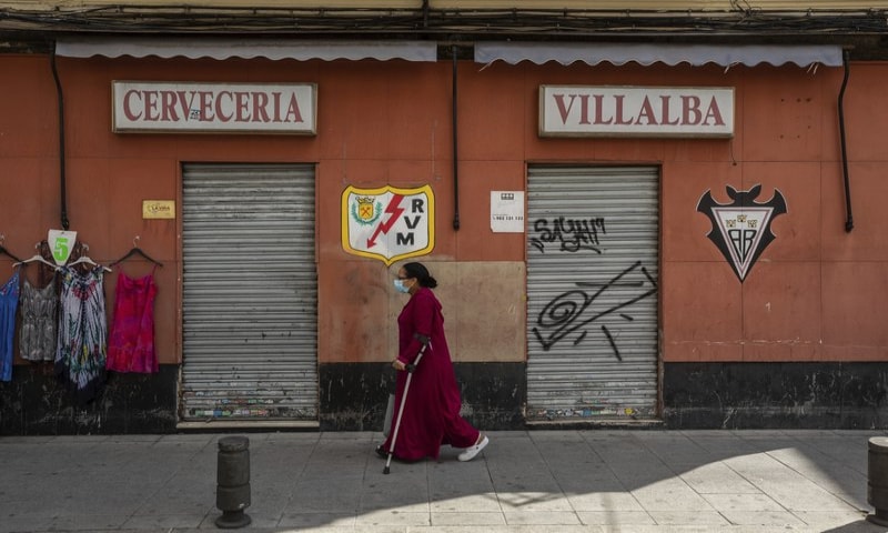 A woman wearing a face mask to prevent the spread of coronavirus walks in the southern neighbourhood of Vallecas in Madrid, Spain on Monday, September 21. &mdash; AP