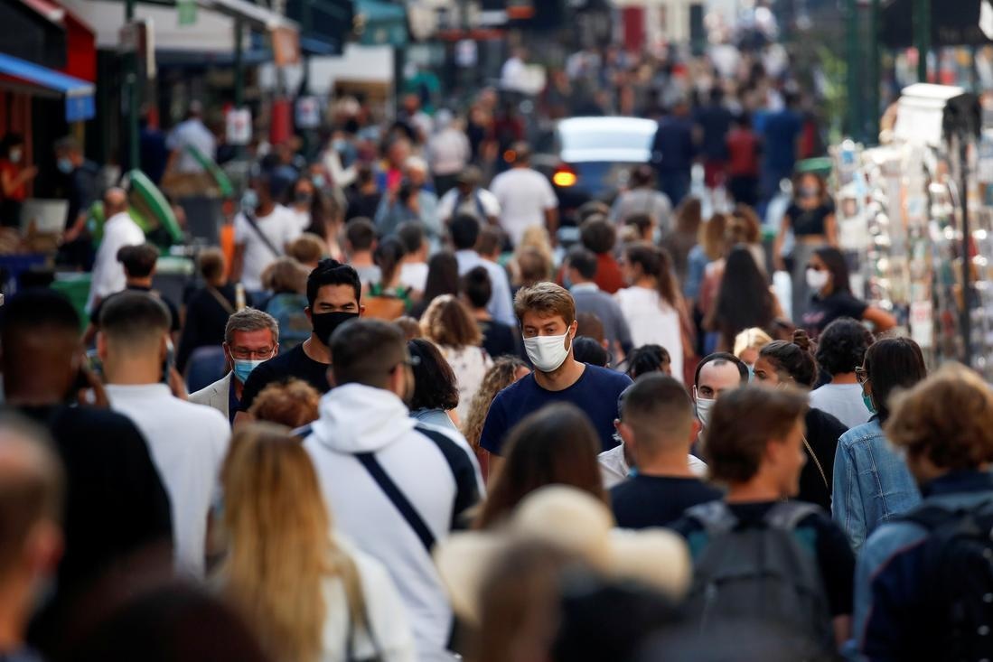 People wearing protective face masks walk in a busy street in Paris as France reinforces mask-wearing in public places as part of efforts to curb a resurgence of the coronavirus. &mdash; Reuters