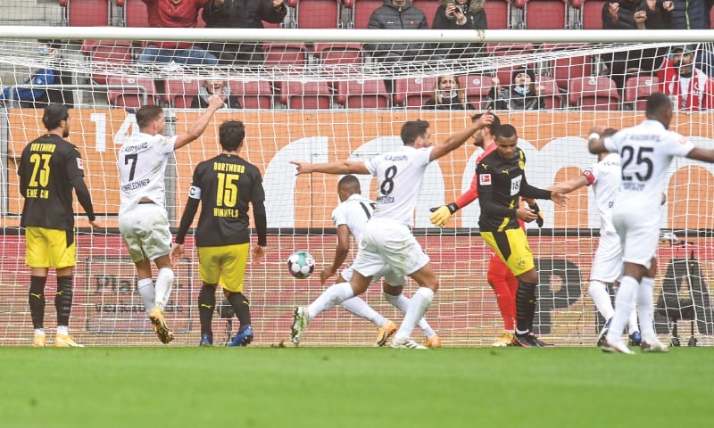 AUGSBURG: FC Augsburg’s Felix Uduokhai (C) scores during the Bundesliga  match against Borussia Dortmund at the WWK Arena.—AFP