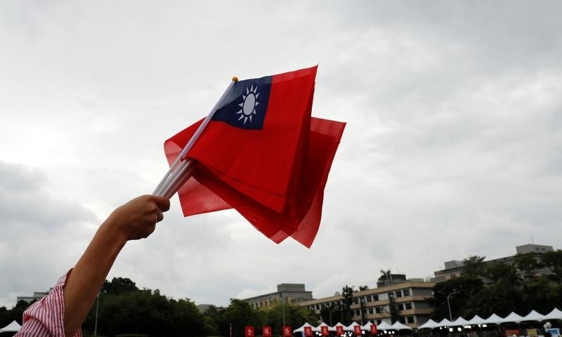 In this file photo, an audience waves Taiwanese flags during the National Day celebrations in Taipei on October 10, 2018. — Reuters