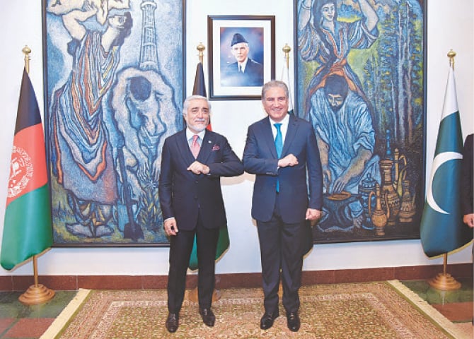 IN this photo released by Foreign Ministry, Abdullah Abdullah bumps elbows with Foreign Minister Shah Mehmood Qureshi before their meeting on Monday.&mdash;AP