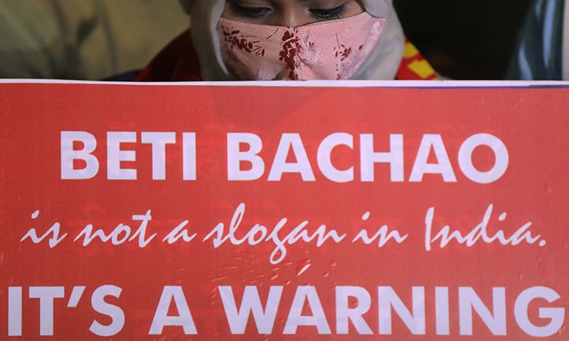 A woman holds a placard during a protest after the death of a rape victim on a street in Mumbai on September 30. — Reuters