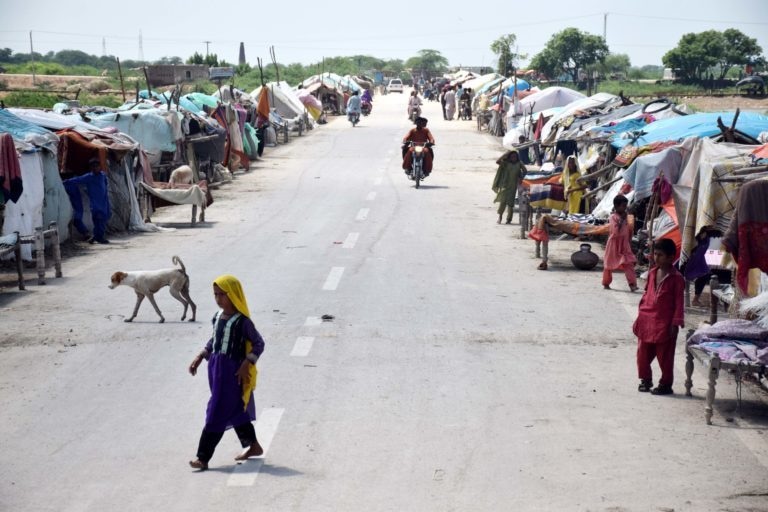 Rain-hit communities have shifted to highlands and roads in Mirpurkhas district and set up improvised tents. They were displaced from their villages due to heavy rains in August. — Photo by Yasir Rajput/The Third Pole