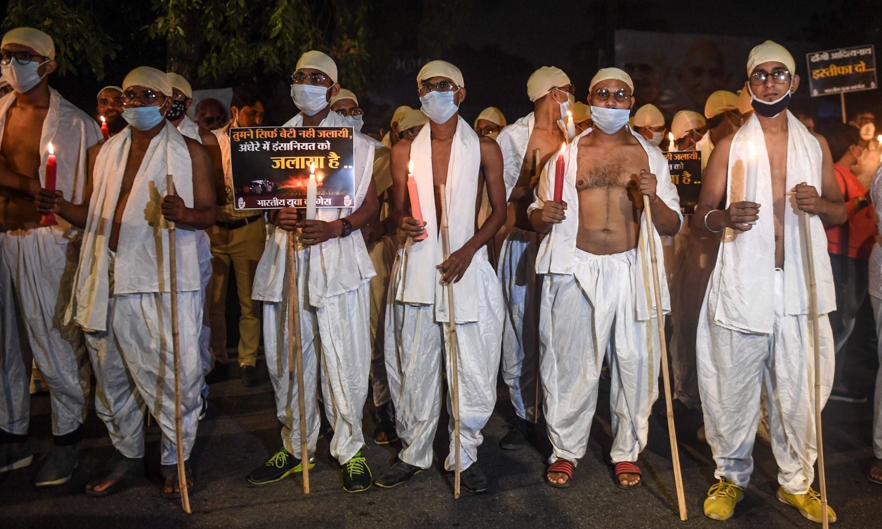 Activists of Indian Youth Congress, dressed as Mahatma Gandhi on the occasion of his birth anniversary marked as the 'Gandhi Jayanti' day, attend a candle march protest against the gang-rape of a woman in Uttar Pradesh, in New Delhi on October 2. — AFP