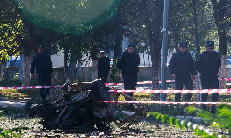 Members of Azerbaijan's security forces, inspect the damage following an overnight missile attack by Armenian forces, in the city of Ganja,  on October 8. —  AP