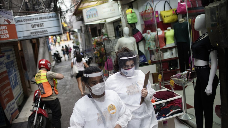 Health workers walk through the Rocinha slum to test people for Covid-19 as part of a rapid test campaign by the civilian organisation "Bora Testar", or "Let's Test" in Rio de Janeiro, Brazil on Oct 8. — AP