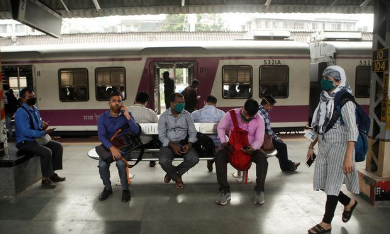 Commuters wait on a railway platform after trains were stalled during a power outage in Mumbai, India on Oct 12. &mdash; Reuters