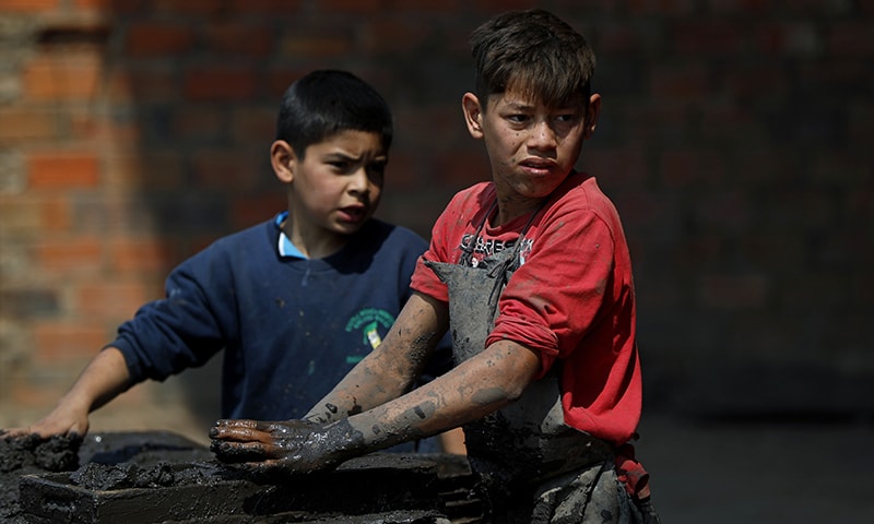 Mauri, 11, left, and Cesar, 13, work at a clay brick factory in Tobati, Paraguay on Friday, September 4, 2020. — AP