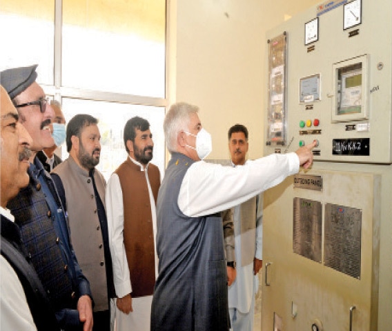 Khyber Pakhtunkhwa Chief Minister Mahmood Khan presses the button at the newly-built grid station in Bajaur on Friday. &mdash; Dawn