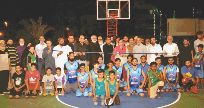 PLAYERS are seen with Irshad Ali Sodhar and other guests and officials at the inauguration of the Rashid Minhas basketball tournament.