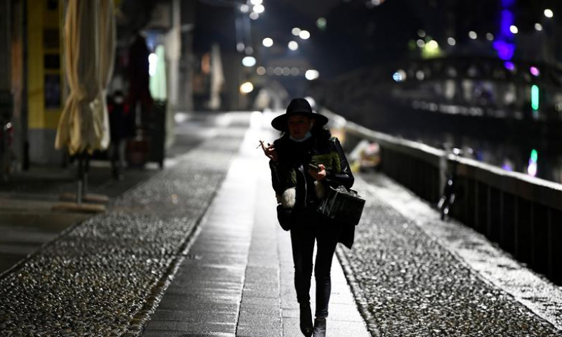 A woman walks on Navigli Grandi as the region of Lombardy imposes a curfew after being hit by a surge of coronavirus infections, in Milan, Italy. — Reuters