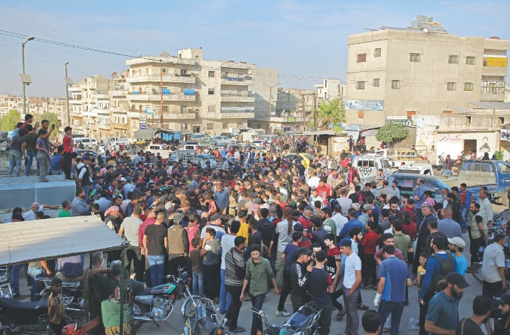 IDLIB: Syrians take part in the funeral of 10 fighters with a Turkey-backed rebel faction following their death in a Russian air strike.—AFP