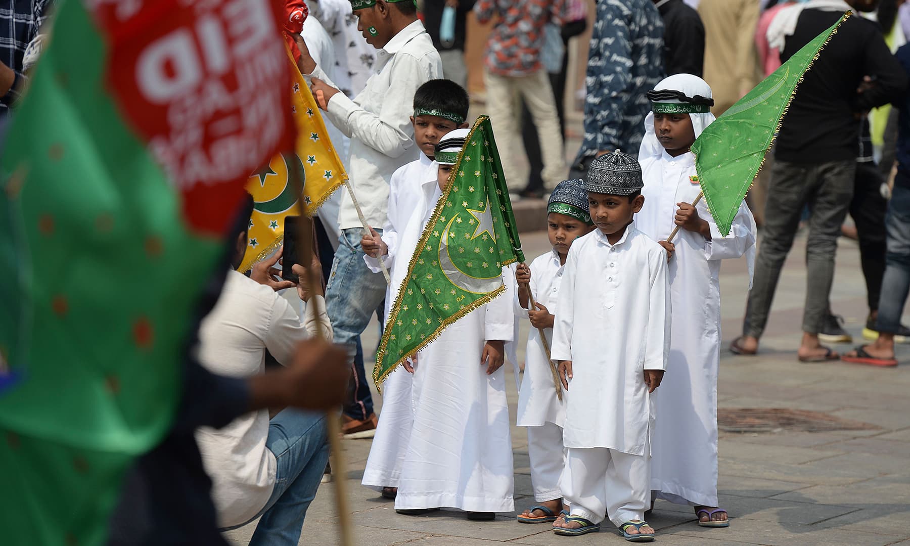 Muslim devotees take pictures as they participate in a procession during Eid-i-Miladun Nabi in Hyderabad, India on October 30. — AFP