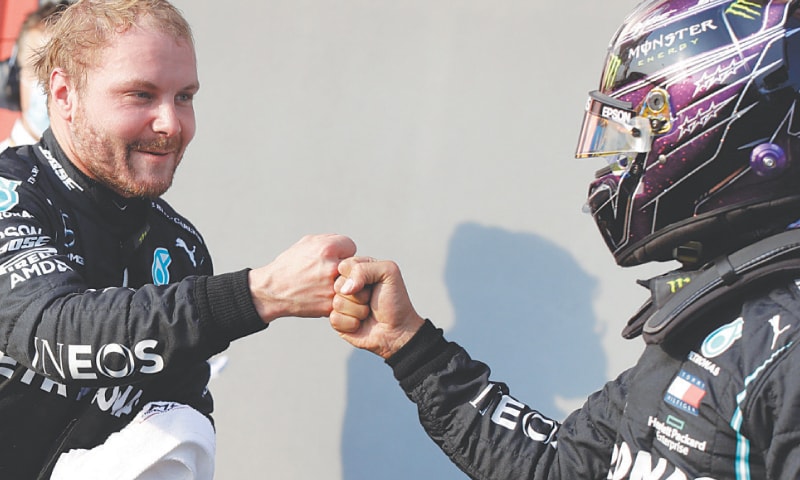 IMOLA: Mercedes’ Valtteri Bottas (L) is congratulated with a fist bump by team-mate Lewis Hamilton on Saturday. — AP IMOLA: Mercedes’ Valtteri Bottas (L) is congratulated with a fist bump by team-mate Lewis Hamilton on Saturday. — AP