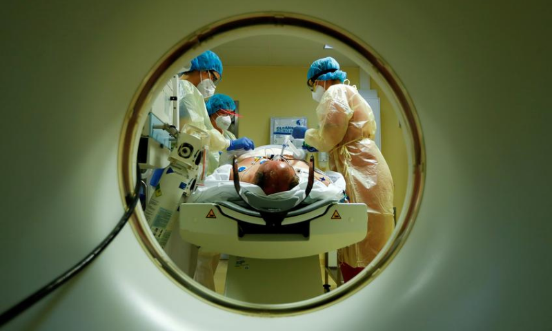 Members of the medical staff in protective suits treat a patient suffering from the coronavirus with a computer tomograph in the Intensive Care Unit (ICU) at Havelhoehe community hospital in Berlin, Germany on October 30. — Reuters