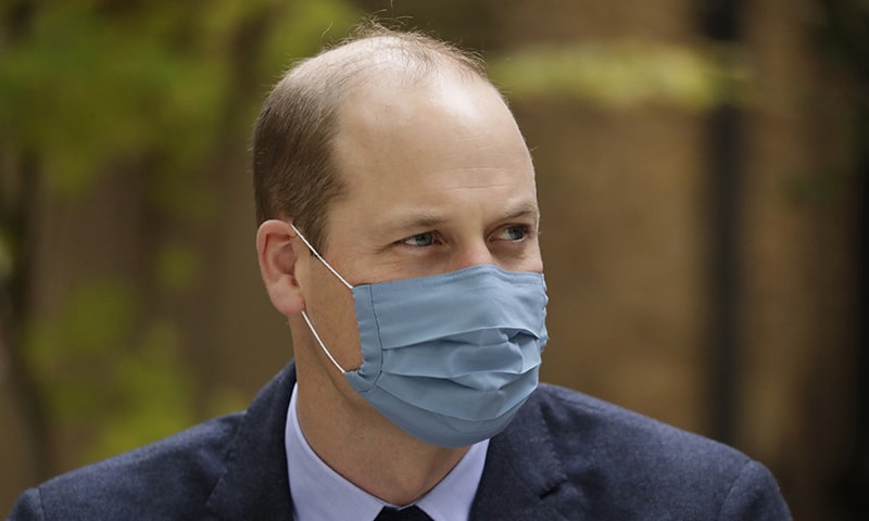 In this October 20, file photo, wearing a face covering to curb the spread of the coronavirus Britain's Prince William meets pharmacist Joyce Duah as he and his wife visit St. Bartholomew's Hospital in London, to mark the launch of the nationwide "Hold Still" community photography project. &mdash; AP