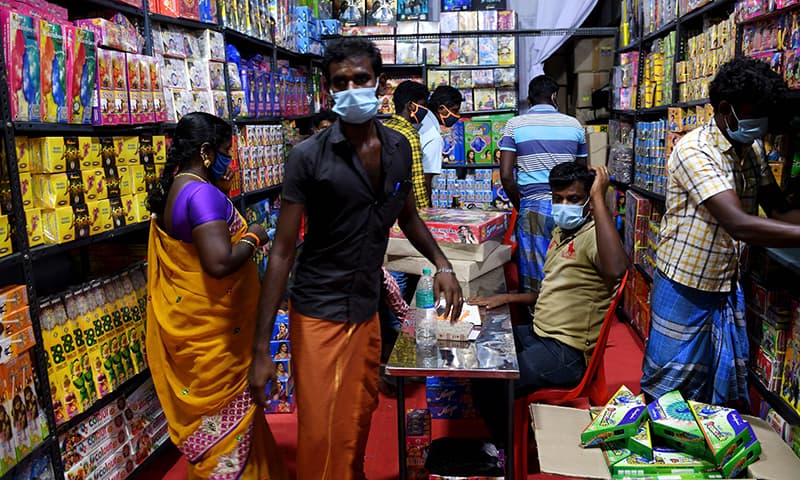 Customers buy firecrackers at a shop ahead of Diwali, the Hindu festival of lights, in Chennai on November 9. — AFP