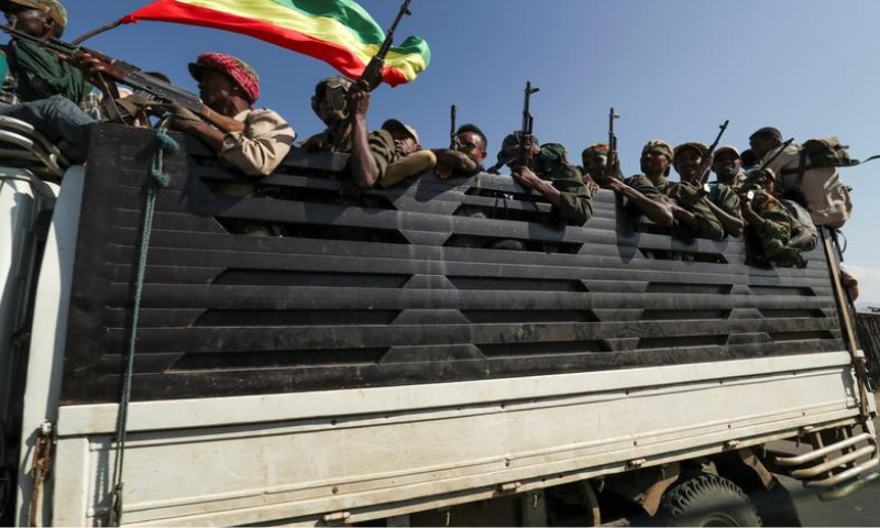 Members of Amhara region militias ride on their truck as they head to face the Tigray People's Liberation Front (TPLF), in Sanja, Amhara region near a border with Tigray, Ethiopia on Nov 9. &mdash; Reuters