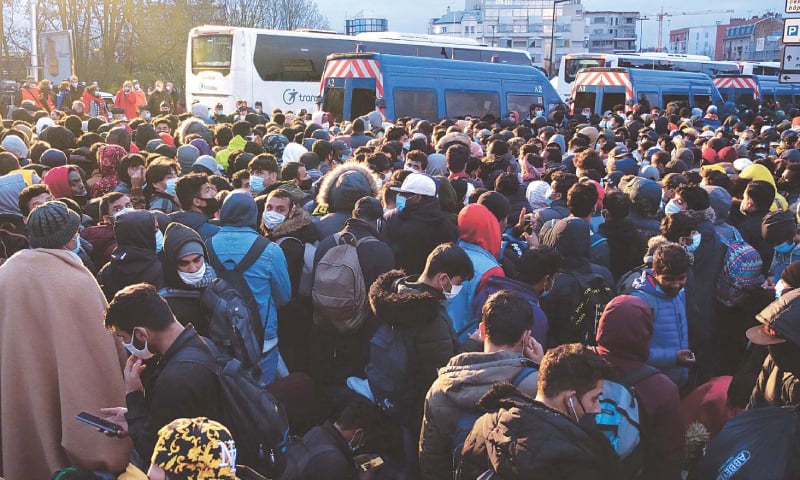 Paris: Migrants wait to be evacuated by French gendarmes at a makeshift camp in the Saint-Denis suburb of Paris on Tuesday.&mdash;Reuters