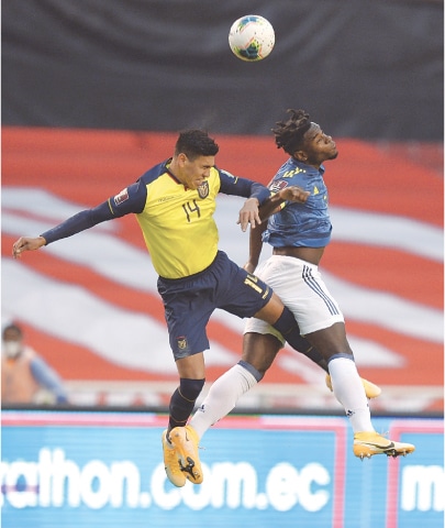 QUITO (Ecuador): Xavier Arreaga (L) of Ecuador and Colombia’s Duvan Zapata jump for a header during their World Cup qualifier.—AP