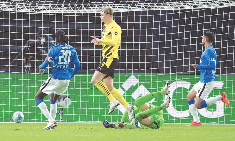 BERLIN: Borussia Dortmund’s Erling Haaland (C) scores against Hertha BSC during their Bundesliga fixture at the Olympic Stadium.—AP