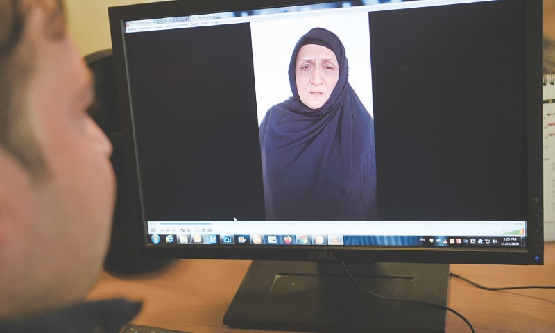 A man watches videos of Muzghan (left) her aunt Nasreen on a computer screen.&mdash;AFP