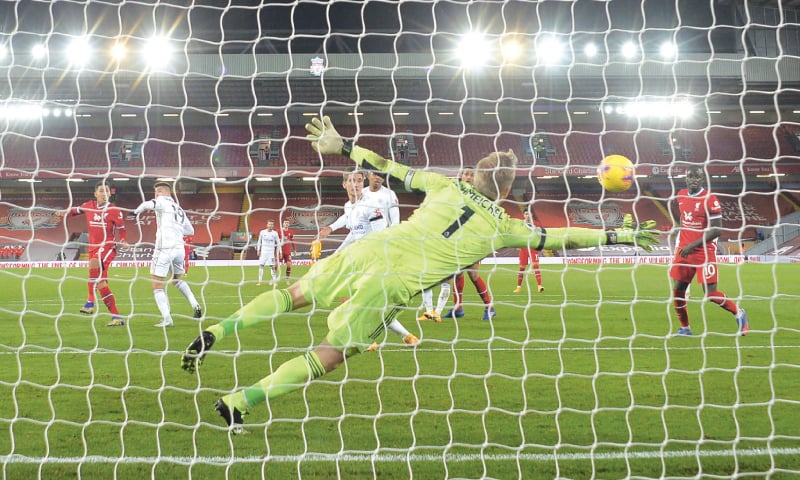 LIVERPOOL: Leicester City&rsquo;s goalkeeper Kasper Schmeichel tries to make a save as Roberto Firmino (L), scores Liverpool&rsquo;s third goal during the English Premier League fixture at Anfield.&mdash;AP