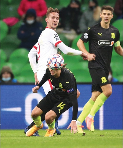 KRASNODAR (Russia); Krasnodar’s Kristoffer Olsson (bottom) vies for the ball with Sevilla’s Luuk de Jong during the Group ‘E’ fixture at the Krasnodar Stadium.—AP