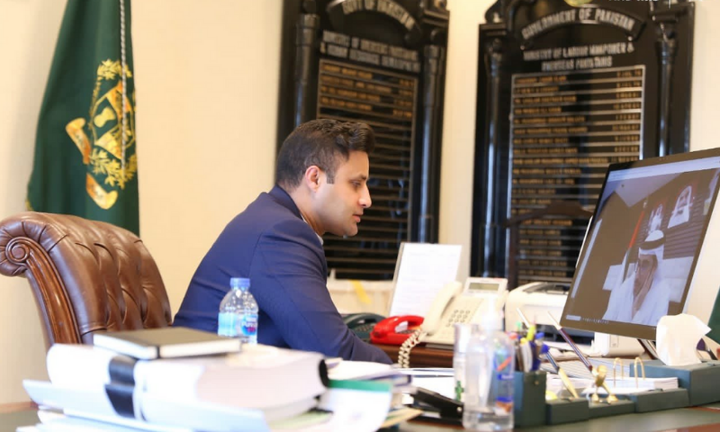 SAPM Syed Zulfiqar Bukhari speaks to UAE Minister for Human Resources and Emiratisation Nasser bin Thani Al Hamli in a virtual meeting. — Photo courtesy PTI Twitter