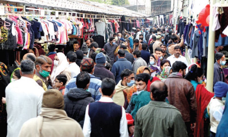 People crowd the weekly bazaar in Islamabad’s Aabpara area on Sunday in total disregard to the health guidelines to protect against Covid-19. — Photo by Mohammad Asim