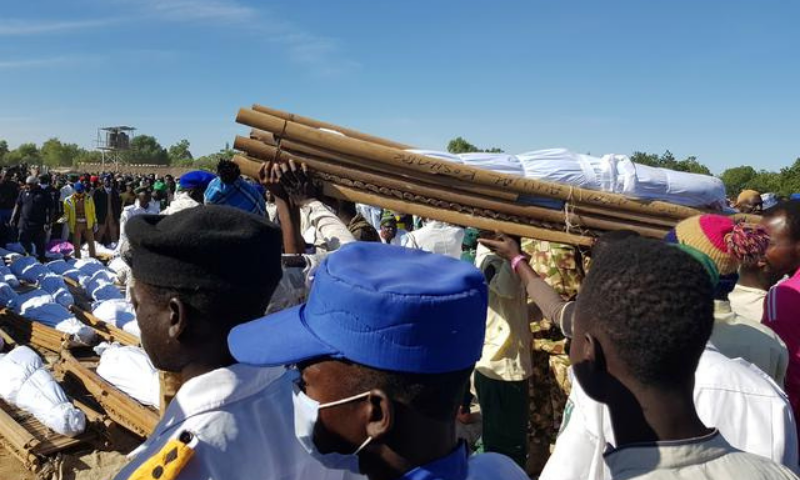 Men carry the bodies of people killed by militant attack, during a mass burial in Zabarmari, in the Jere local government area of Borno State, in northeast Nigeria, on Nov 29. — Reuters