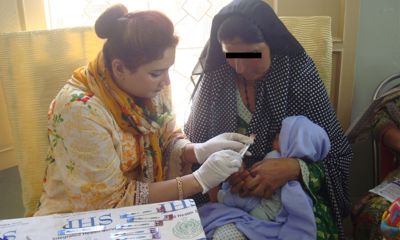 A volunteer tests a baby for HIV as the mother looks on in this May 2019 file photo. — Photo by writer