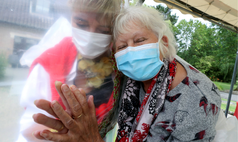 Lily Hendrickx, 83, a resident at Belgian nursing home “Le Jardin de Picardie” enjoys hugs and cuddles with Marie-Christine Desoer, the director of the residence, through a wall made with plastic sheets to protect against potential coronavirus infection, in Peruwelz, Belgium on July 1, 2020. — Reuters